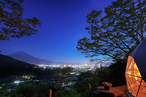 Night view of Shakushi Gateway Camp with Mount Fuji in the background